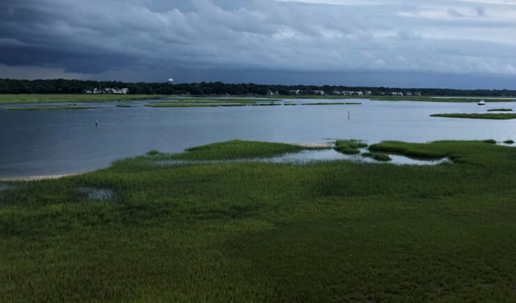 Vast tidal wetland with storm approaching